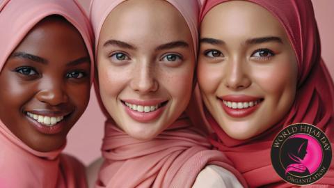 Three women in pink hijabs smiling; World Hijab Day Organization logo in the corner.