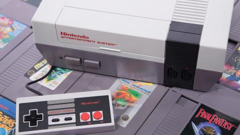 A Nintendo Entertainment System with a controller, surrounded by various NES game cartridges.