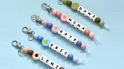 Four beaded keychains with names: DANI, NINA, KATE, ERIC, LENI, each with colorful beads and flower charms.